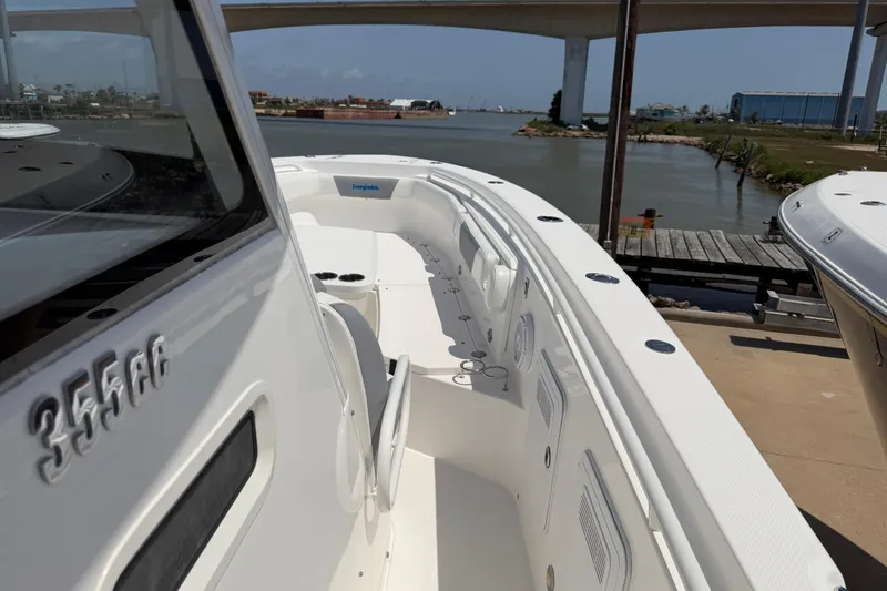 Slide: The Image of 2018 Everglades 355 Center Console boat docked near a bridge, showcasing sleek design. - 15