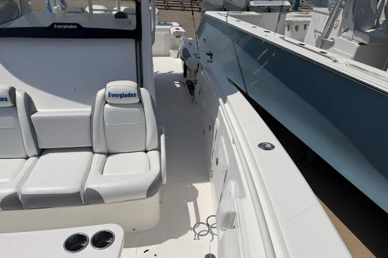 Slide: The Image of 2018 Everglades 355 Center Console boat interior with white seating and cup holders. - 20
