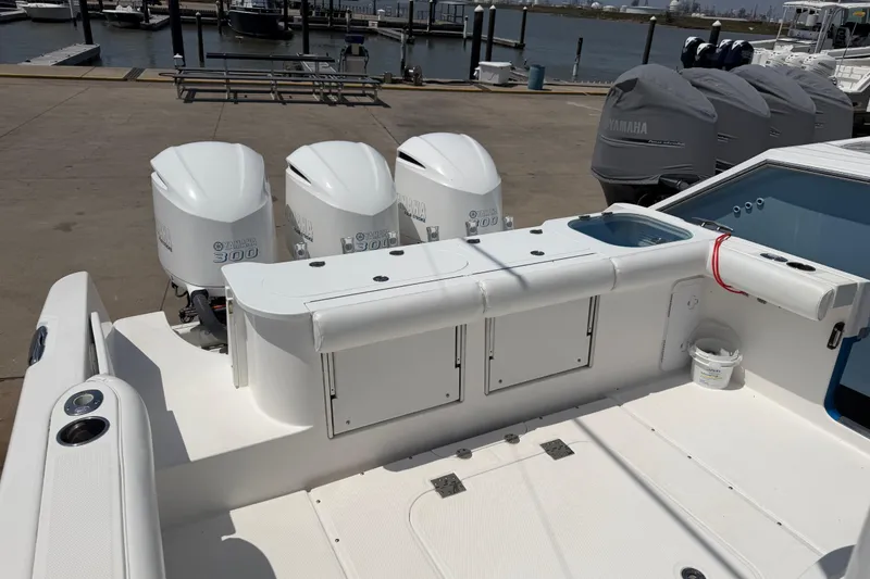 Slide: The Image of 2018 Everglades 355 Center Console boat with triple Yamaha 300 engines at dock. - 22