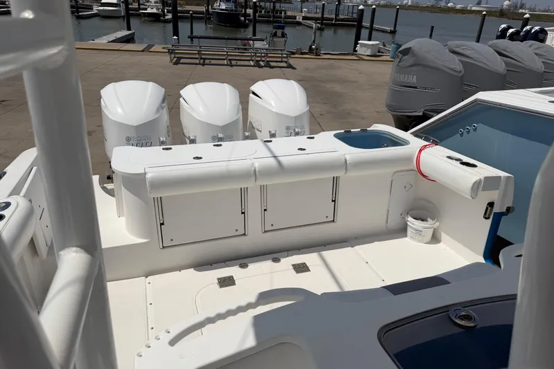Slide: The Image of 2018 Everglades 355 Center Console boat with triple Yamaha engines docked at marina. - 23