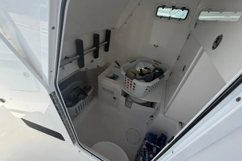 Slide: The Image of Interior of 2018 Everglades 355 Center Console boat with storage and laundry baskets. - 27