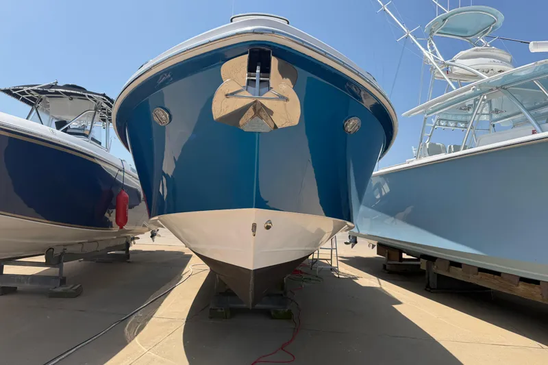 Slide: The Image of 2018 Everglades 355 Center Console boat docked between two others. - 3