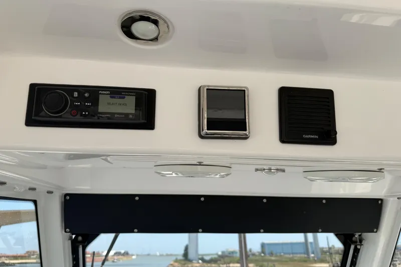 Slide: The Image of 2018 Everglades 355 Center Console dashboard with Fusion and Garmin controls. - 32