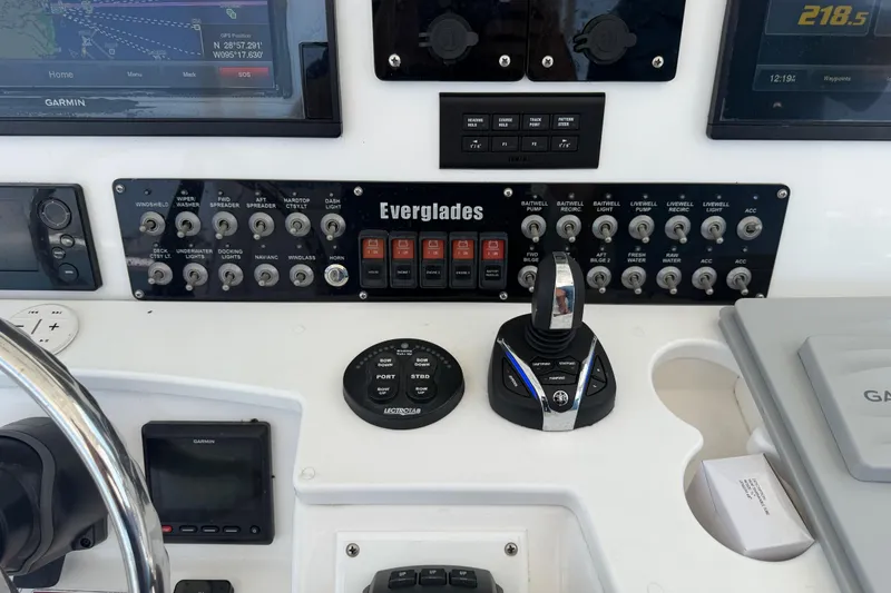 Slide: The Image of Control panel of 2018 Everglades 355 Center Console boat with navigation and switches. - 35