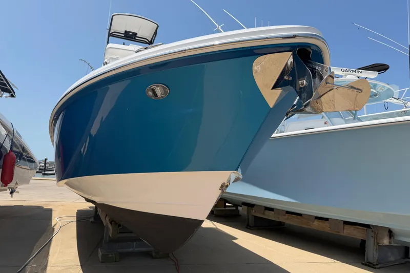 Slide: The Image of 2018 Everglades 355 Center Console boat on display, featuring a sleek blue hull. - 4
