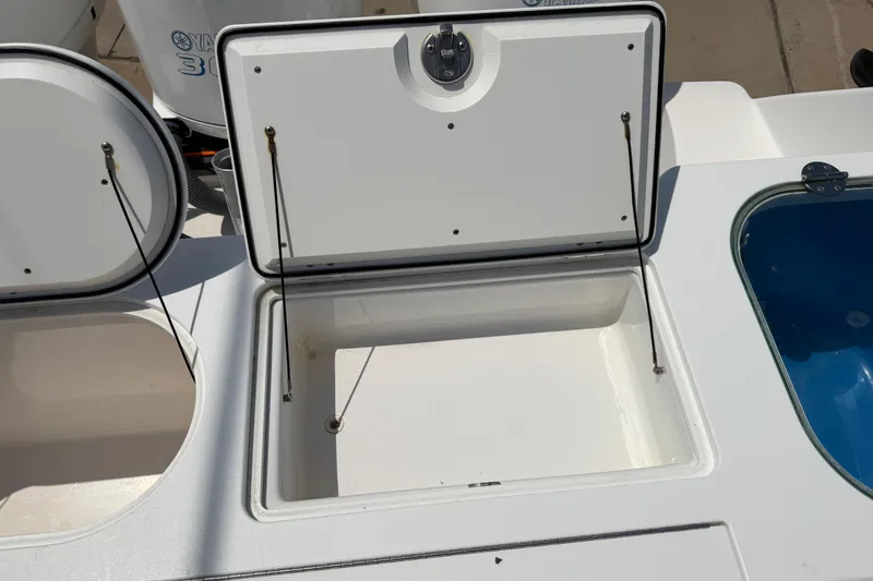 Slide: The Image of Open storage compartment on 2018 Everglades 355 Center Console boat. - 41