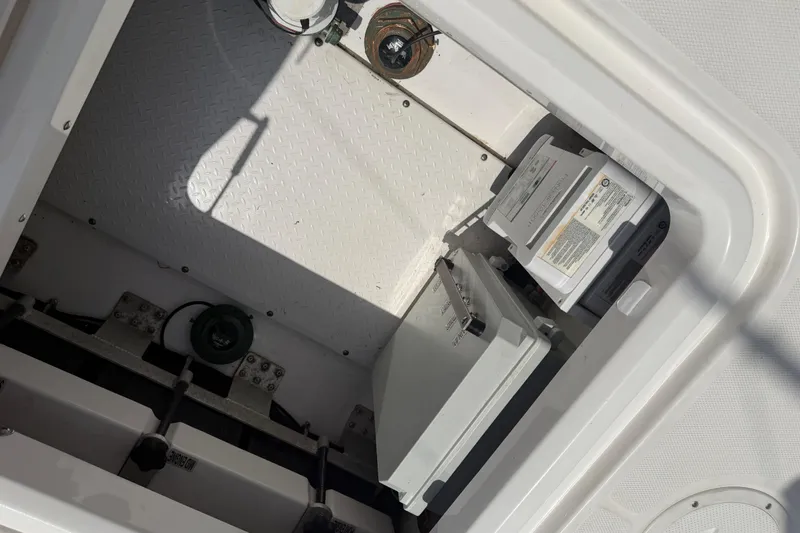 Slide: The Image of Storage compartment of 2018 Everglades 355 Center Console boat, featuring equipment and wiring. - 45