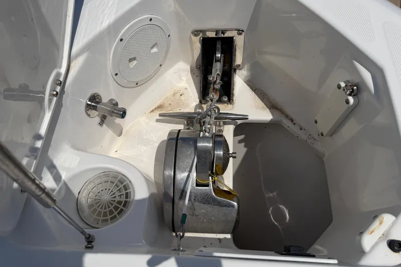 Slide: The Image of Anchor compartment of 2018 Everglades 355 Center Console boat, featuring winch and cleats. - 49