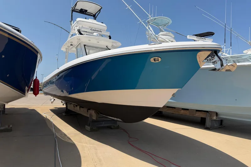 Slide: The Image of 2018 Everglades 355 Center Console boat displayed on a dock under clear blue sky. - 5