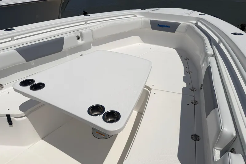 Slide: The Image of 2018 Everglades 355 Center Console boat interior with table and cup holders. - 50