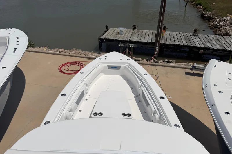 Slide: The Image of 2018 Everglades 355 Center Console boat docked near a wooden pier. - 60