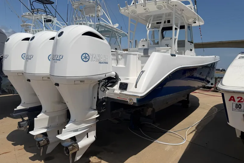 Slide: The Image of 2018 Everglades 355 Center Console boat with triple Yamaha 300 outboard engines. - 7