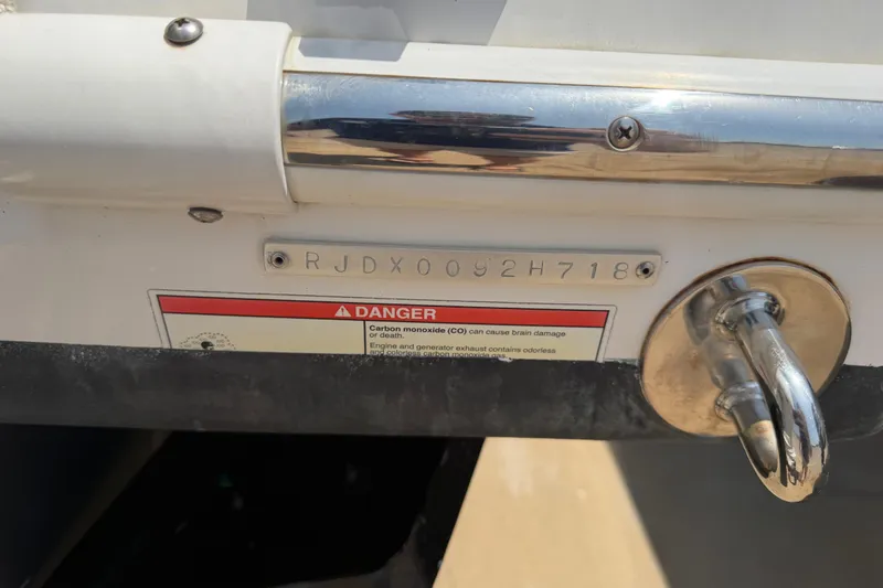 Slide: The Image of 2018 Everglades 355 Center Console boat with visible hull identification number and safety warning label. - 71