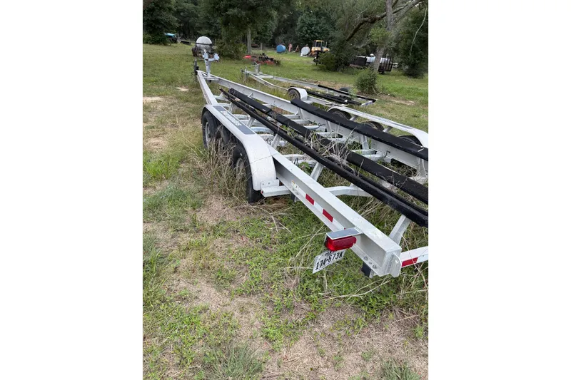 Slide: The Image of Trailer for 2018 Everglades 355 Center Console boat parked on grassy area. - 72