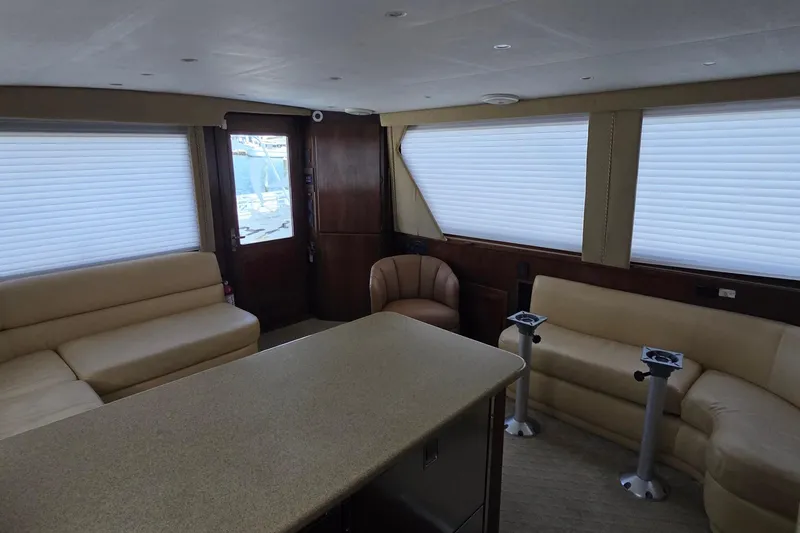 Slide: The Image of Interior of 1989 Hatteras 52 Convertible yacht with beige seating and modern decor. - 13