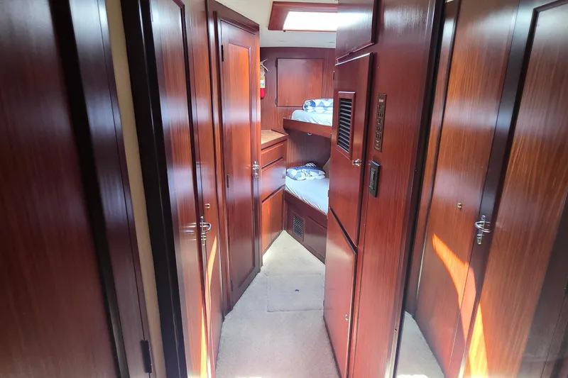 Slide: The Image of Interior of 1989 Hatteras 52 Convertible yacht with wooden paneling and bunk beds. - 28