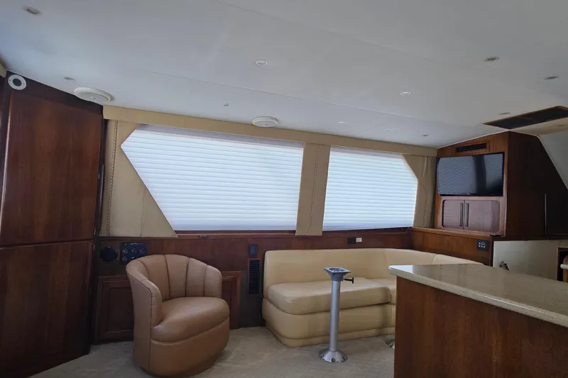 Slide: The Image of Luxurious interior of 1989 Hatteras 52 Convertible yacht with leather seating and wood finishes. - 8