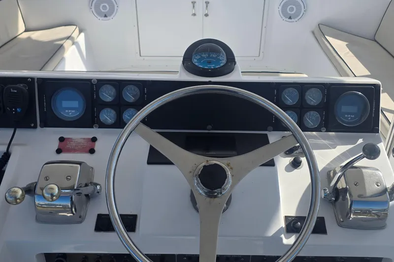 Slide: The Image of Helm of 1989 Hatteras 52 Convertible yacht with steering wheel and control gauges. - 37