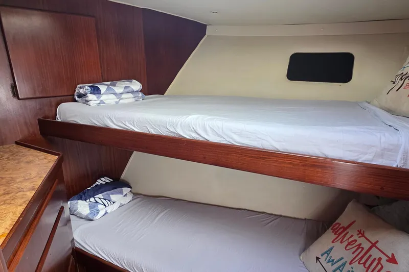 Slide: The Image of Cozy bunk beds in 1989 Hatteras 52 Convertible yacht cabin with wooden interior. - 29