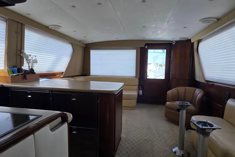 Slide: The Image of Luxurious interior of a 1989 Hatteras 52 Convertible yacht with elegant seating and cabinetry. - 15