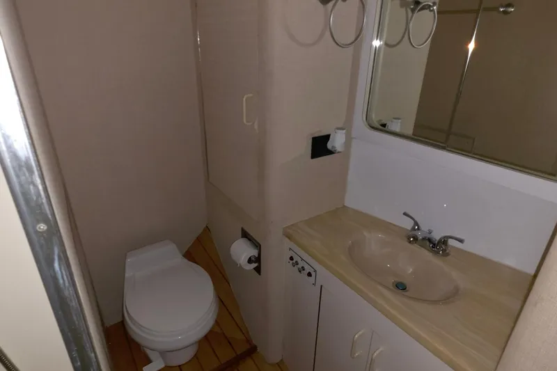 Slide: The Image of Bathroom interior of 1989 Hatteras 52 Convertible yacht, featuring sink and toilet. - 24