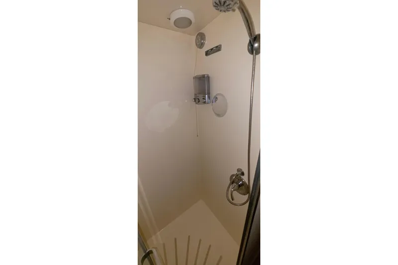 Slide: The Image of Shower area inside 1989 Hatteras 52 Convertible yacht, featuring modern fixtures. - 26