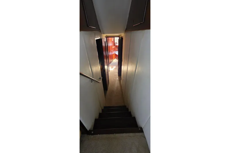Slide: The Image of Interior staircase of 1989 Hatteras 52 Convertible yacht, leading to cabin area. - 17