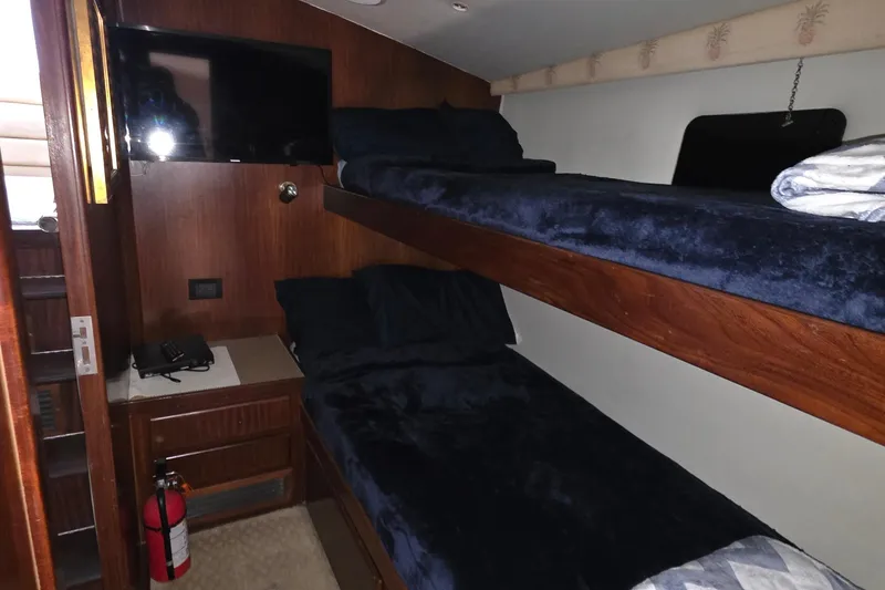 Slide: The Image of Interior cabin of 1989 Hatteras 52 Convertible with bunk beds and TV. - 18