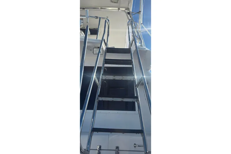 Slide: The Image of Staircase on 1989 Hatteras 52 Convertible yacht with metal railings. - 35