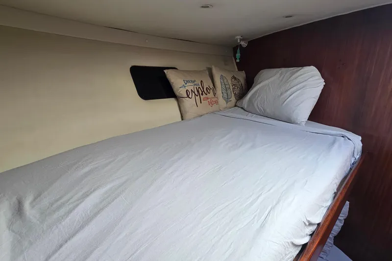 Slide: The Image of Cozy cabin bed inside 1989 Hatteras 52 Convertible yacht with decorative pillows. - 30