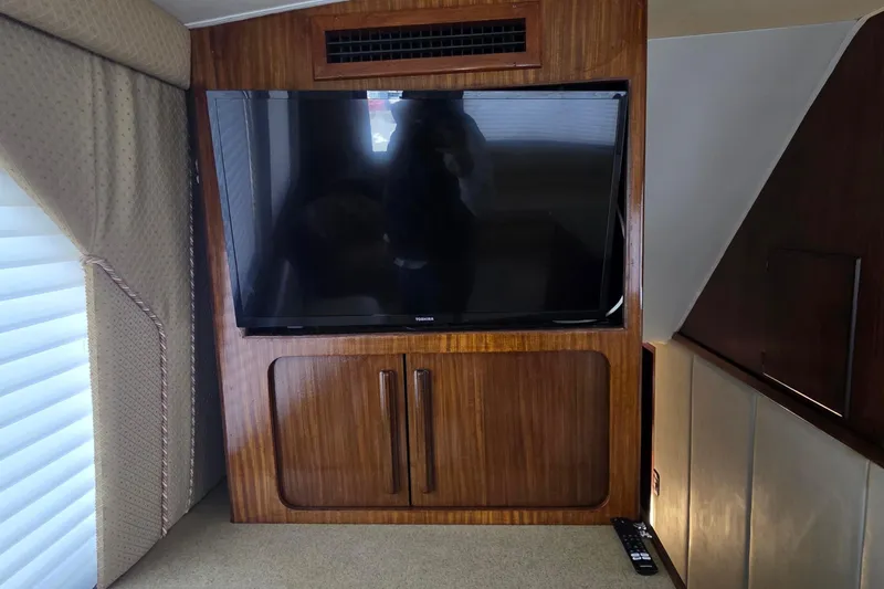Slide: The Image of Flat-screen TV in 1989 Hatteras 52 Convertible yacht's wooden interior. - 14