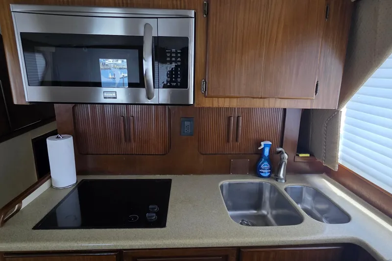Slide: The Image of Galley kitchen in 1989 Hatteras 52 Convertible yacht with microwave and dual sink. - 10