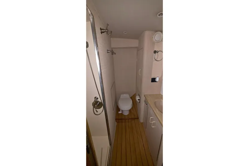 Slide: The Image of Bathroom interior of 1989 Hatteras 52 Convertible yacht, featuring toilet and sink. - 23