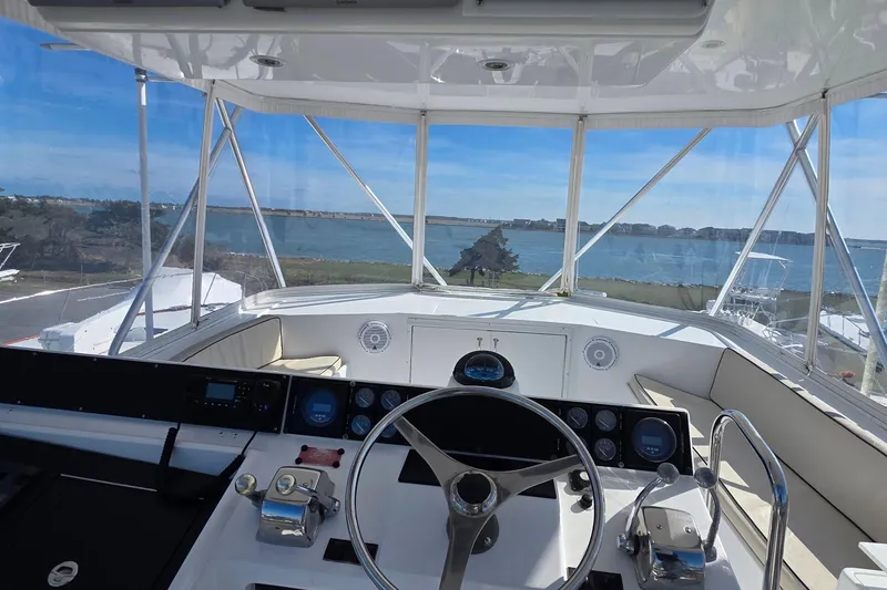 Slide: The Image of Interior view of 1989 Hatteras 52 Convertible yacht cockpit with ocean backdrop. - 40