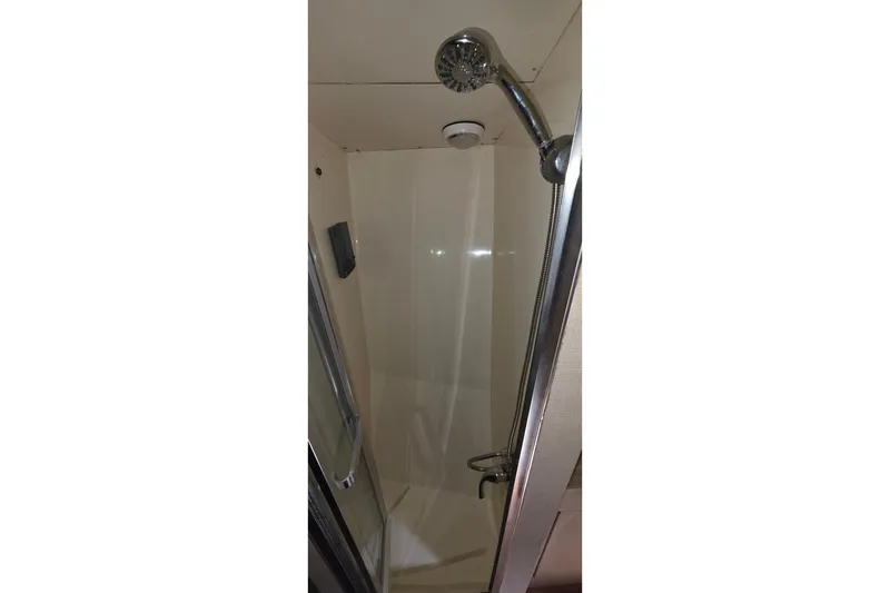 Slide: The Image of Shower area inside 1989 Hatteras 52 Convertible yacht, featuring chrome fixtures. - 21
