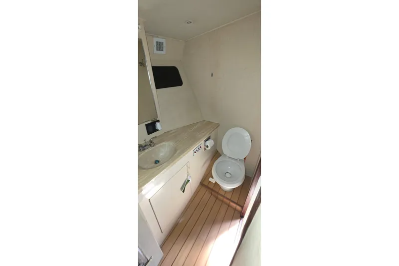 Slide: The Image of Bathroom interior of 1989 Hatteras 52 Convertible yacht, featuring sink and toilet. - 20