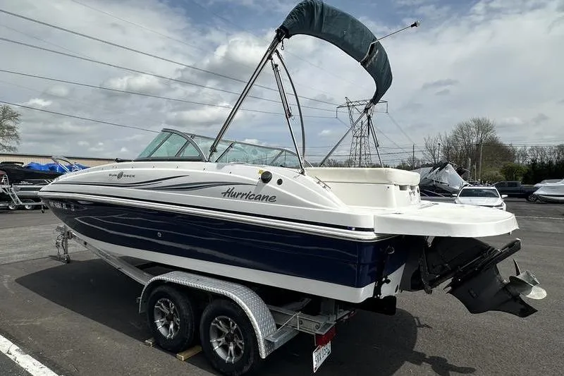 Slide: The Image of 2014 Hurricane SunDeck 187 IO boat on trailer under cloudy sky. - 10