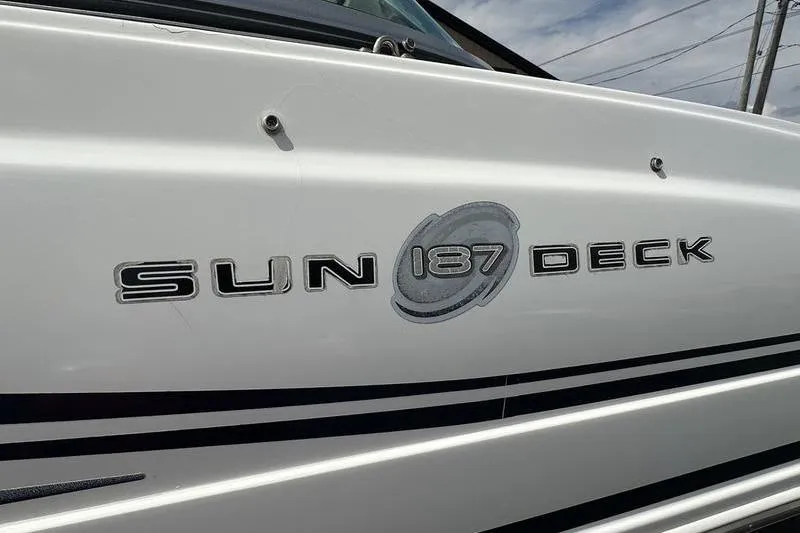 Slide: The Image of 2014 Hurricane SunDeck 187 IO boat logo on white exterior. - 11