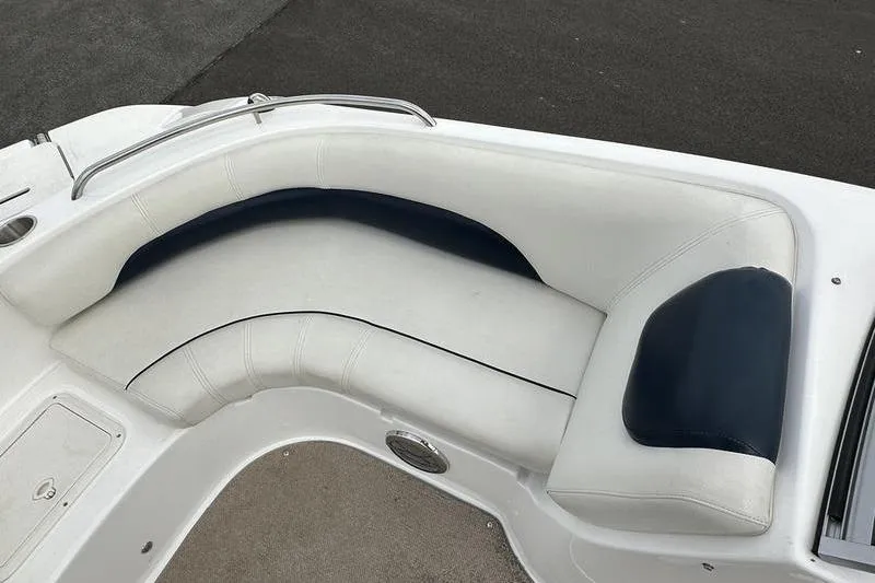 Slide: The Image of 2014 Hurricane SunDeck 187 IO boat interior with white and navy seating. - 16