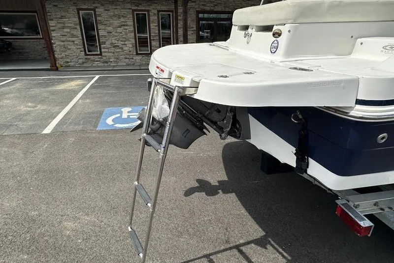 Slide: The Image of 2014 Hurricane SunDeck 187 IO boat with swim platform and ladder in parking lot. - 21