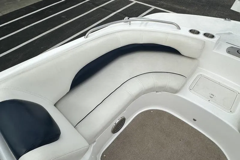 Slide: The Image of 2014 Hurricane SunDeck 187 IO boat interior with white and navy seating. - 23