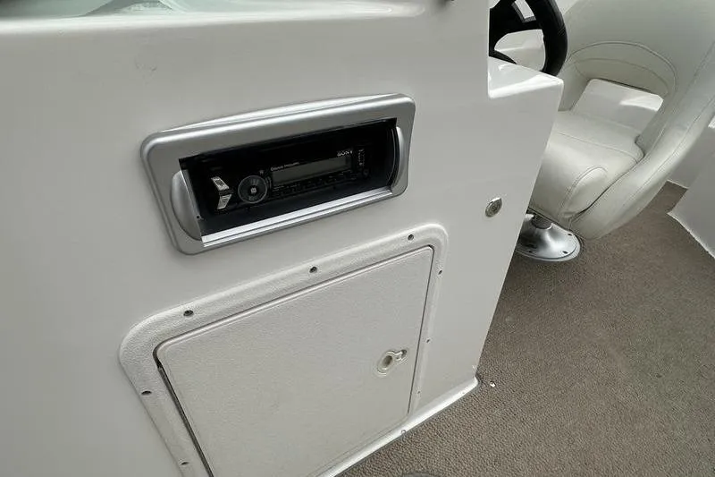 Slide: The Image of 2014 Hurricane SunDeck 187 IO boat interior with stereo system and seating. - 27