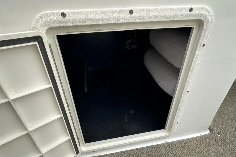 Slide: The Image of Storage compartment on a 2014 Hurricane SunDeck 187 IO boat, featuring an open hatch. - 28