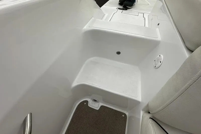 Slide: The Image of 2014 Hurricane SunDeck 187 IO boat interior with white seating and step detail. - 3