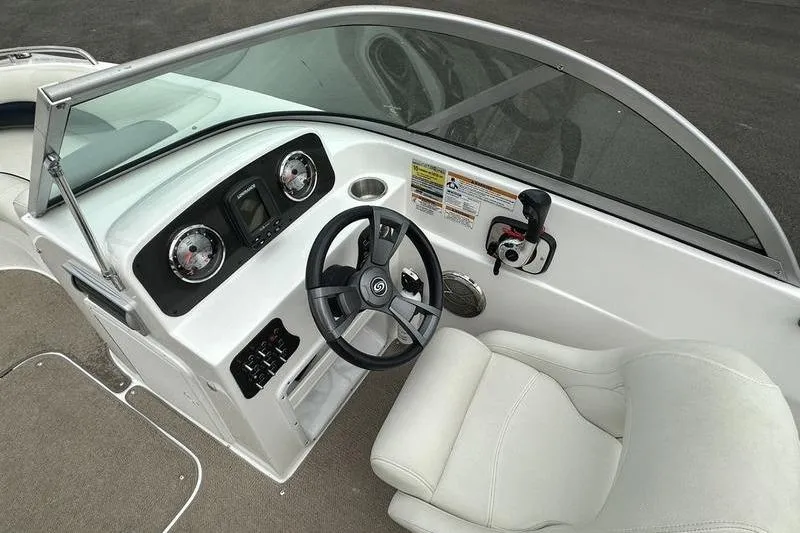 Slide: The Image of 2014 Hurricane SunDeck 187 IO boat cockpit with steering wheel and dashboard controls. - 32