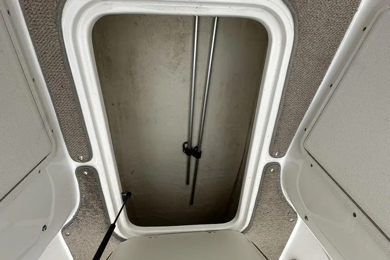 Slide: The Image of Open storage compartment on a 2014 Hurricane SunDeck 187 IO boat. - 34