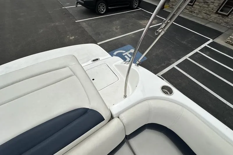 Slide: The Image of 2014 Hurricane SunDeck 187 IO boat interior with seating and cup holder in parking lot. - 39
