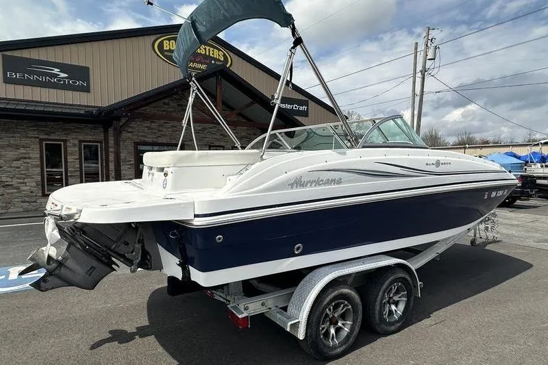 Slide: The Image of 2014 Hurricane SunDeck 187 IO boat on trailer outside dealership. - 4