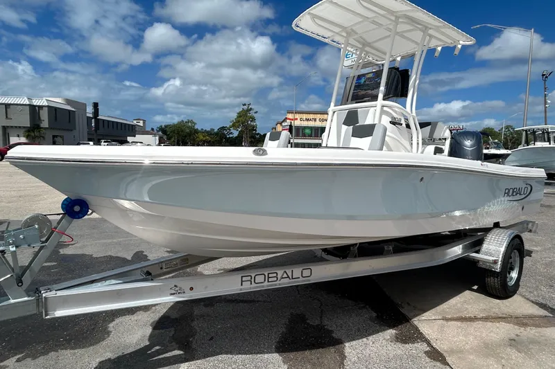 The Image of 2026 Robalo 206 Cayman boat on trailer under clear blue sky. - 0