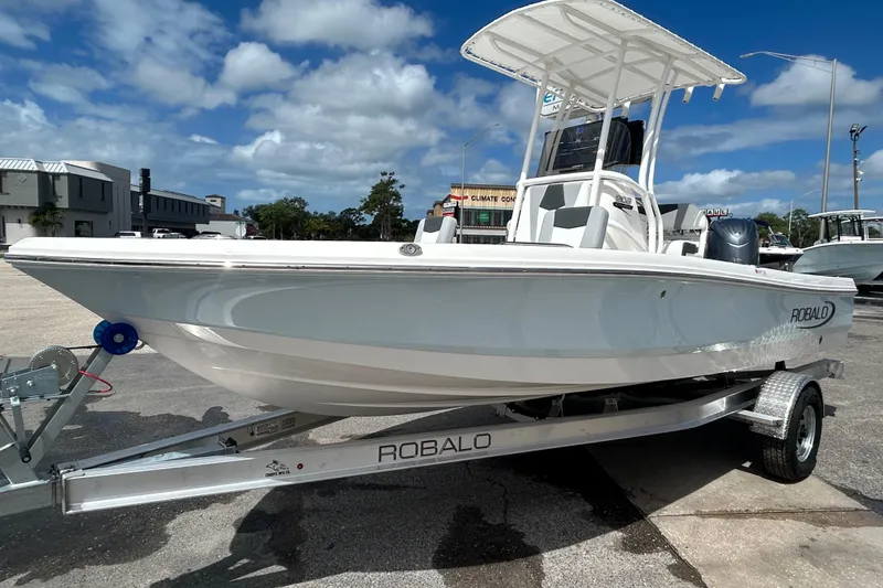Slide: The Image of 2026 Robalo 206 Cayman boat on trailer under blue sky. - 10
